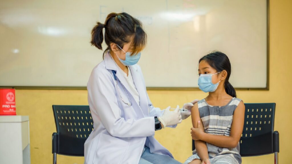 nurse giving a vaccination to a child